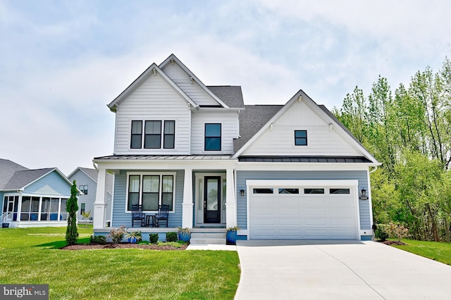 view of front facade featuring an attached garage, a front lawn, a porch, concrete driveway, and a standing seam roof