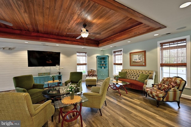living room with visible vents, wood finished floors, ceiling fan, a tray ceiling, and wooden ceiling