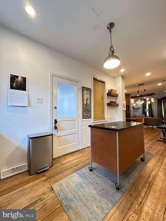 622 Saint Joseph St, Lancaster, PA 17603 - interior space featuring visible vents, dark countertops, hanging light fixtures, open floor plan, and light wood-style flooring