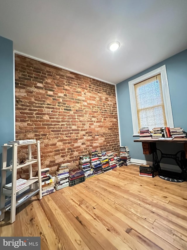 622 Saint Joseph St, Lancaster, PA 17603 - miscellaneous room with brick wall and wood finished floors