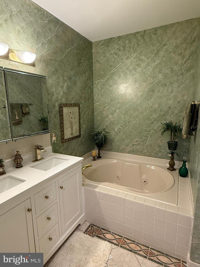 61 Legacy Oaks Dr, Richboro, PA 18954 - bathroom featuring a whirlpool tub, double vanity, tile walls, and tile patterned flooring