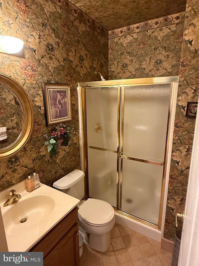 61 Legacy Oaks Dr, Richboro, PA 18954 - bathroom featuring vanity, a shower stall, tile patterned flooring, toilet, and wallpapered walls