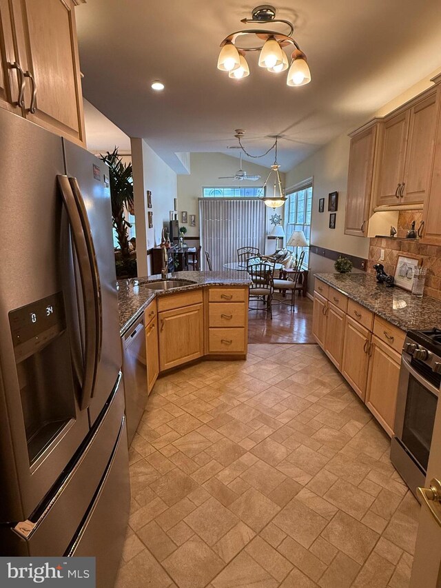 61 Legacy Oaks Dr, Richboro, PA 18954 - kitchen with appliances with stainless steel finishes, a sink, tasteful backsplash, a peninsula, and dark stone countertops