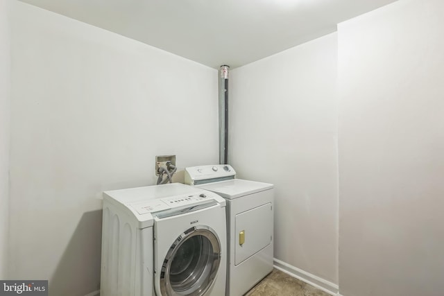 laundry room featuring washer and dryer, laundry area, and baseboards