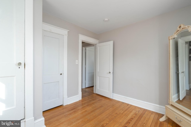 unfurnished bedroom featuring baseboards and light wood-style floors