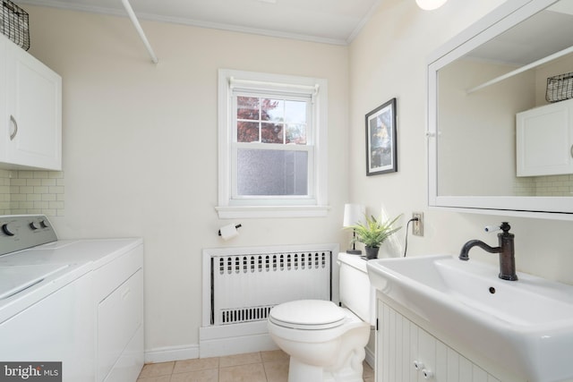 bathroom featuring washing machine and dryer, radiator heating unit, decorative backsplash, vanity, and ornamental molding
