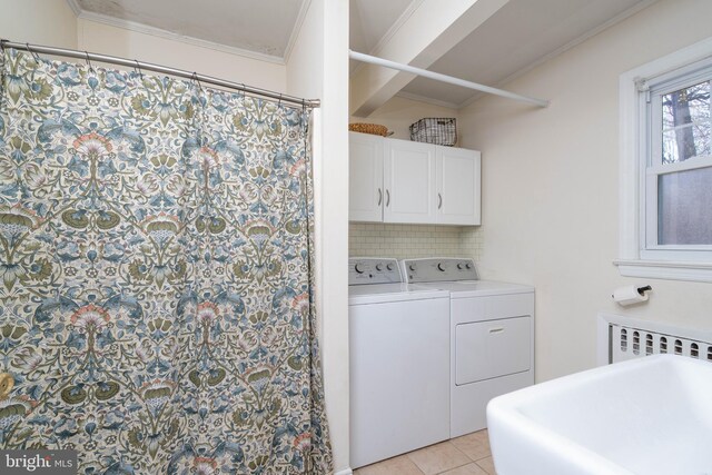 laundry area with radiator heating unit, crown molding, a sink, separate washer and dryer, and light tile patterned floors