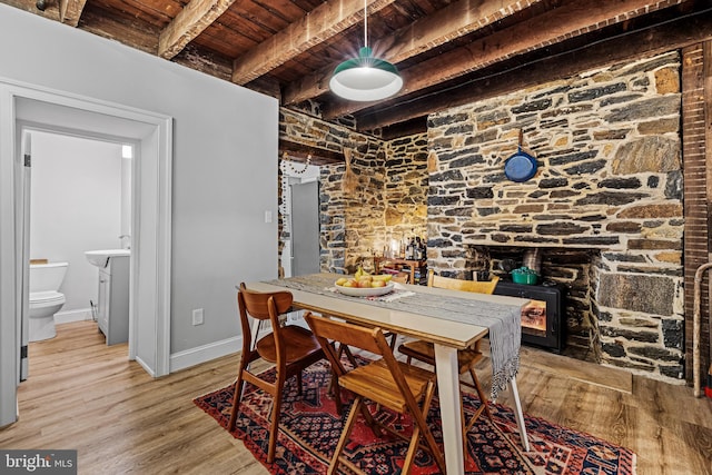 dining space featuring wooden ceiling, baseboards, beam ceiling, and light wood-type flooring