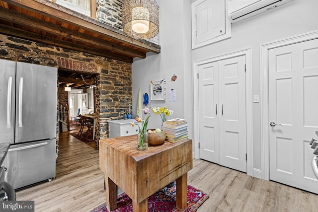 foyer featuring wood ceiling, an AC wall unit, beam ceiling, and light wood-type flooring