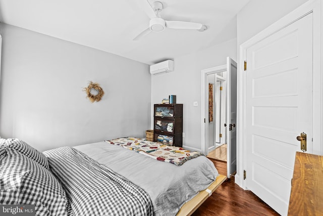 bedroom featuring a ceiling fan, dark wood-style flooring, and a wall unit AC