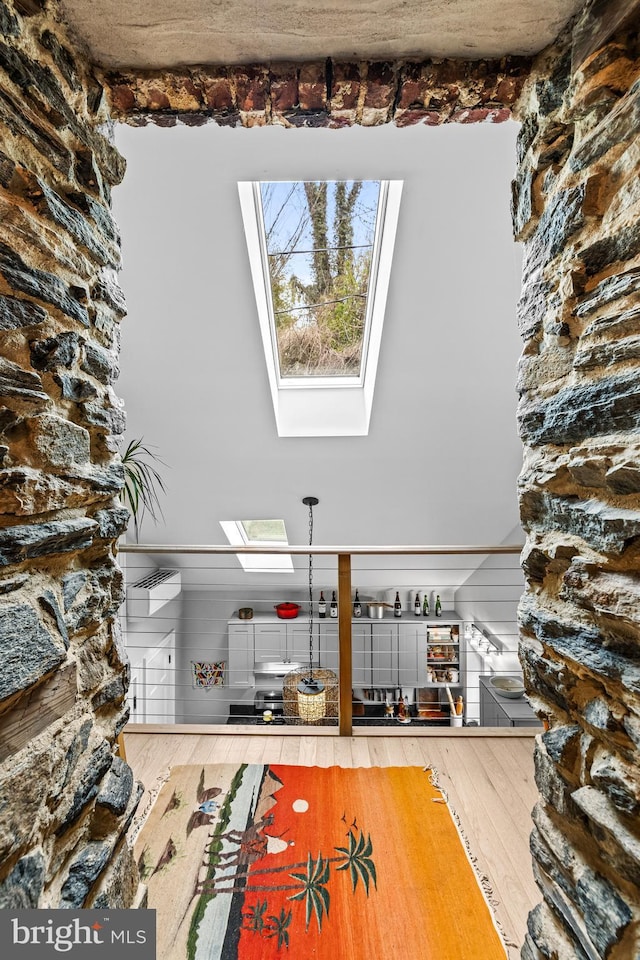 interior space featuring a skylight and wood finished floors