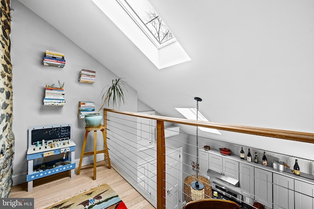 interior space with wood finished floors and a skylight