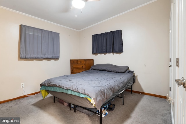 bedroom with baseboards, carpet floors, and crown molding