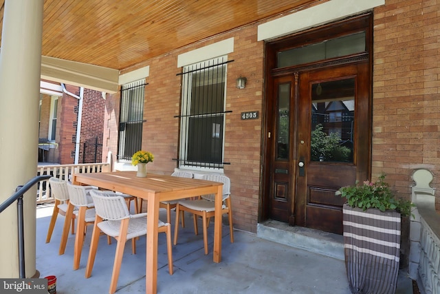 4505 Chester Ave, Philadelphia, PA 19143 - view of exterior entry with brick siding, covered porch, and outdoor dining area