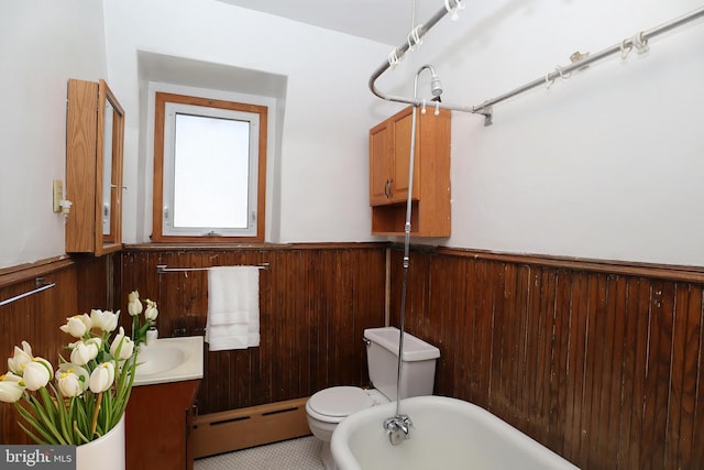 4505 Chester Ave, Philadelphia, PA 19143 - bathroom featuring a baseboard radiator, a wainscoted wall, toilet, vanity, and wooden walls