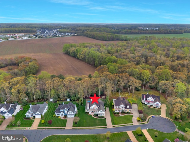 birds eye view of property featuring a residential view and a forest view