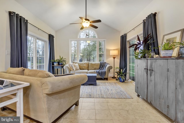 living room with light tile patterned floors, a ceiling fan, and lofted ceiling