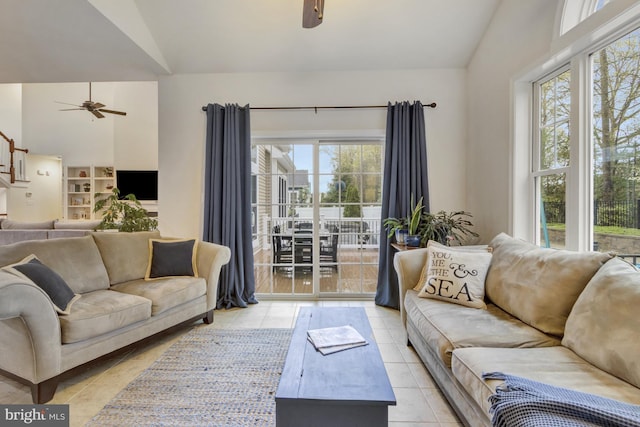 tiled living room featuring a ceiling fan and vaulted ceiling