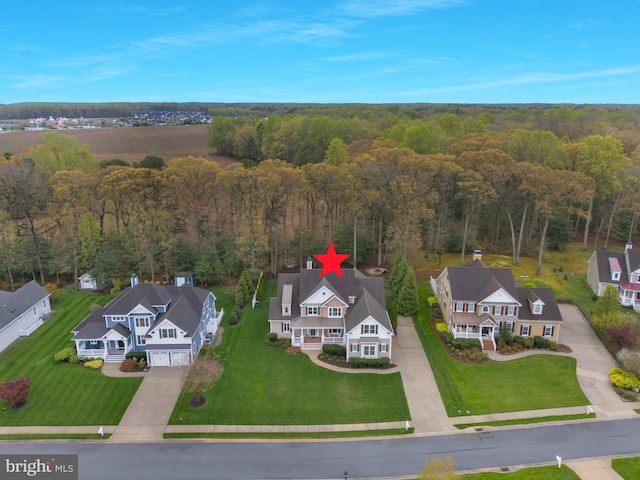 aerial view featuring a wooded view and a residential view