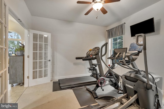 exercise room with french doors and a ceiling fan