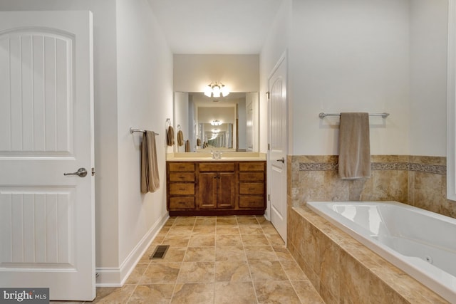 full bathroom with vanity, visible vents, and a bath