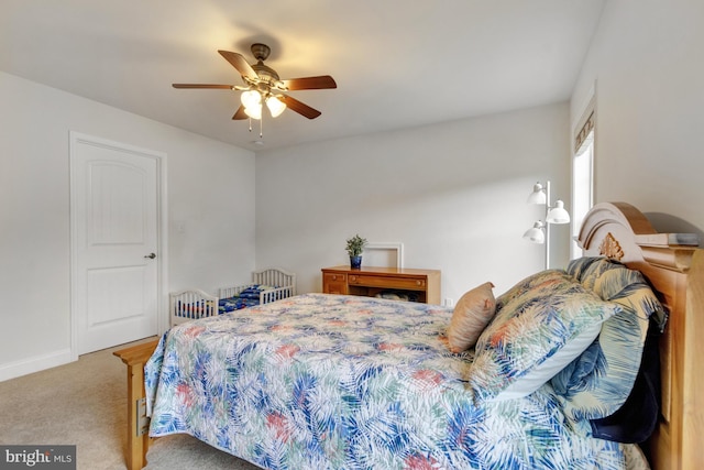 bedroom with ceiling fan, baseboards, and carpet floors