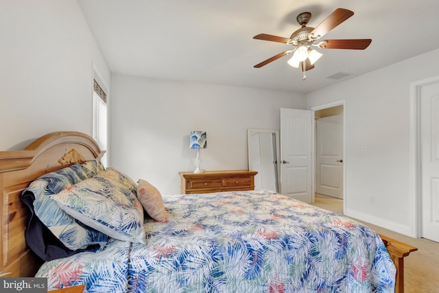 carpeted bedroom with ceiling fan, baseboards, and visible vents