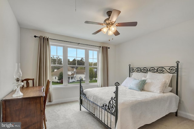 bedroom with carpet flooring, baseboards, and a ceiling fan