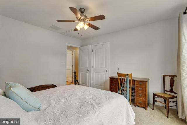 bedroom featuring visible vents, ceiling fan, and light carpet