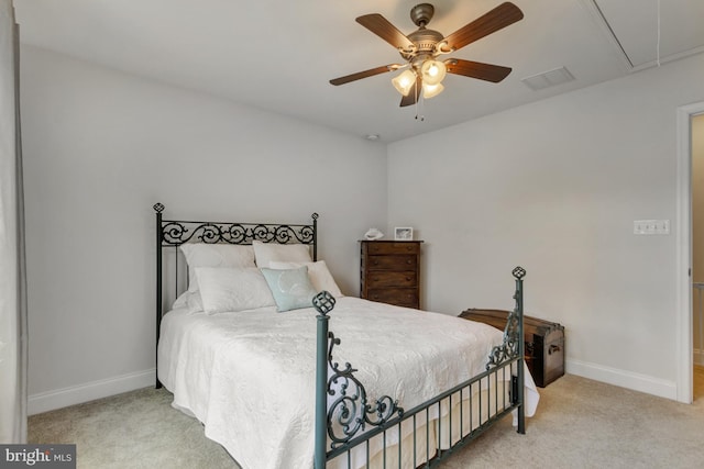 carpeted bedroom with attic access, baseboards, a ceiling fan, and visible vents