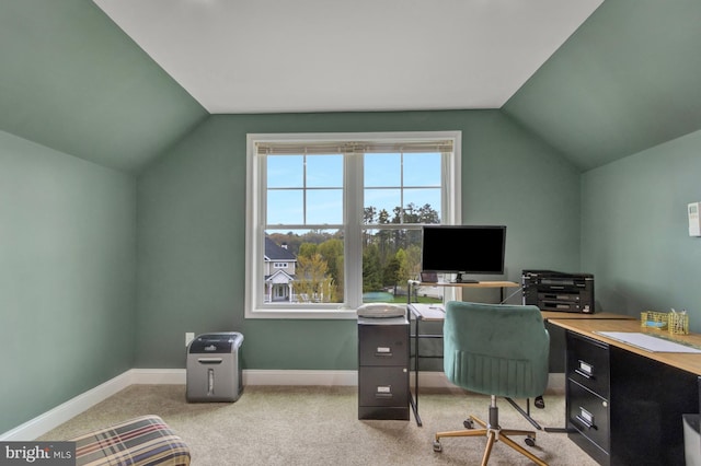 carpeted home office featuring baseboards and vaulted ceiling
