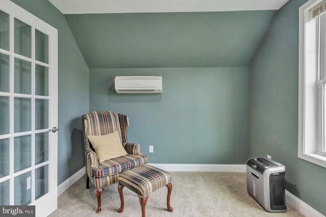 living area featuring carpet floors, baseboards, lofted ceiling, and a wall unit AC