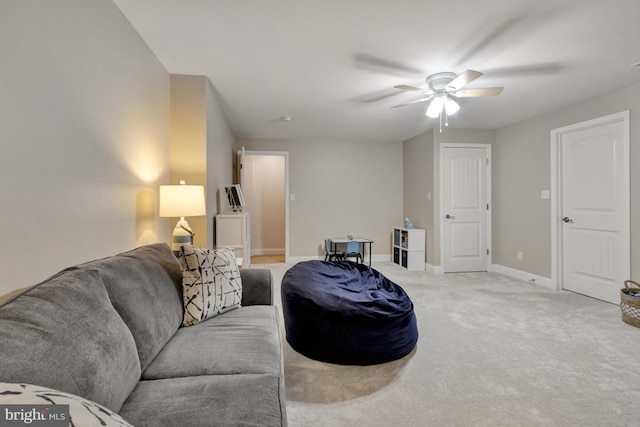 living area with carpet floors, baseboards, and ceiling fan