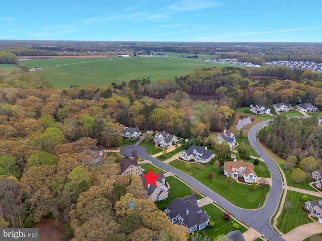 aerial view featuring a forest view and a residential view