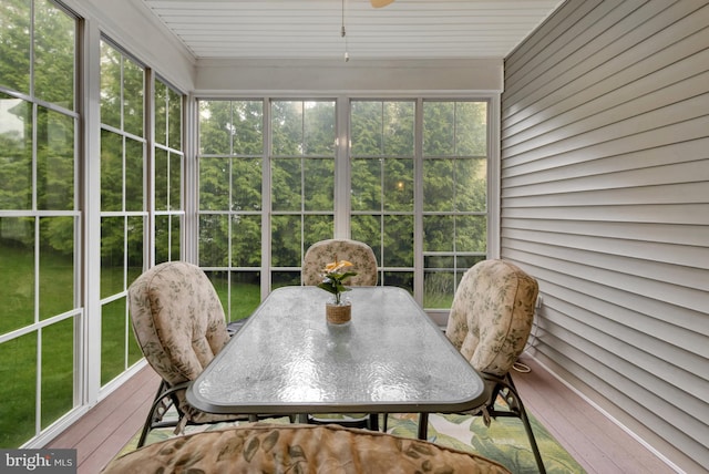 sunroom with outdoor dining area and plenty of natural light