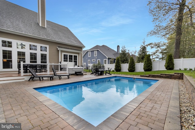 view of pool with a fenced in pool, a patio area, and a fenced backyard
