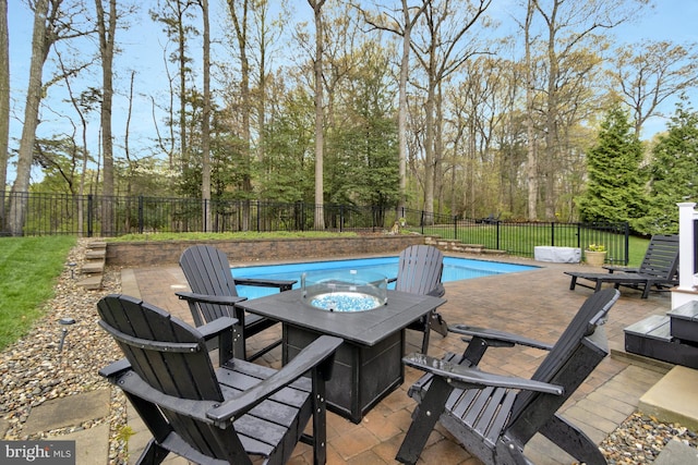 view of pool with a patio area, an outdoor fire pit, a fenced backyard, and a fenced in pool