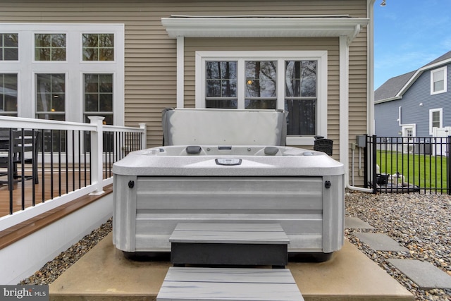 exterior space with fence and a hot tub