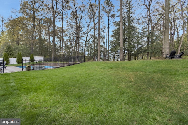 view of yard featuring a fenced in pool and fence