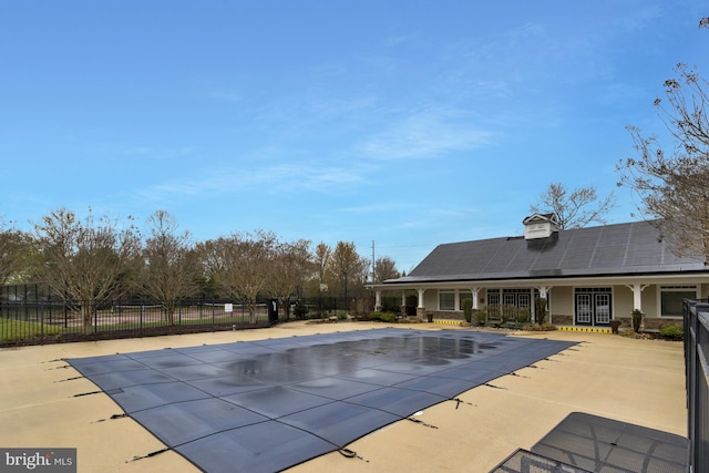 view of swimming pool featuring fence, a fenced in pool, and a patio