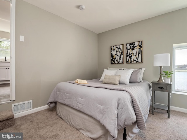 bedroom with visible vents, carpet flooring, and baseboards