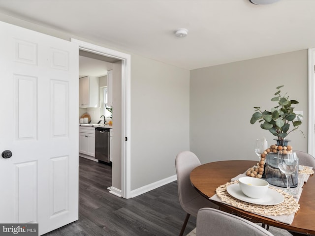 dining room with dark wood finished floors and baseboards