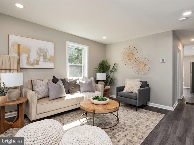 living area with recessed lighting, baseboards, and dark wood-style flooring