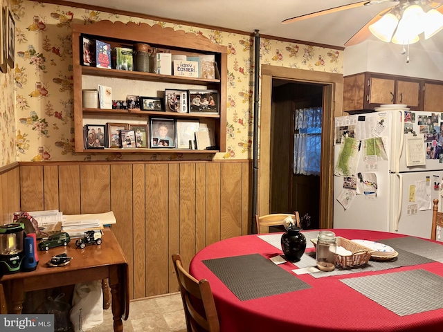 133 Black St, Howard, PA 16841 - dining area featuring wallpapered walls, a wainscoted wall, and ceiling fan
