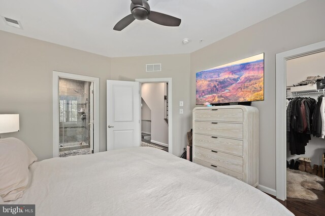 bedroom featuring wood finished floors, a spacious closet, visible vents, and a closet
