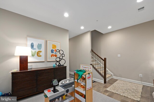 office space with recessed lighting, visible vents, wood finished floors, and baseboards