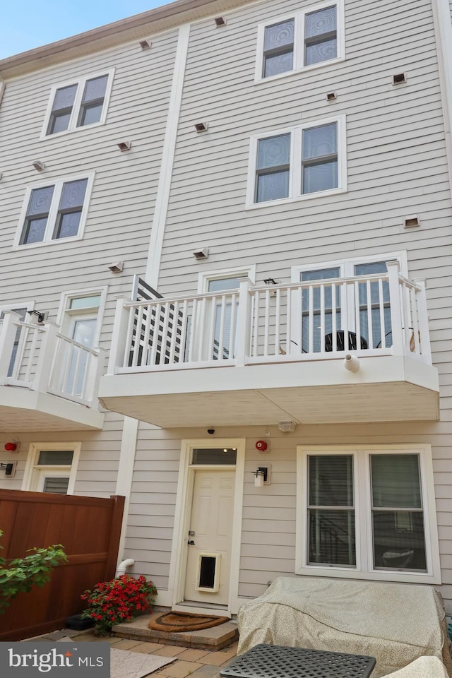 exterior space featuring fence and a balcony