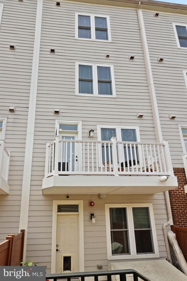 rear view of property featuring a balcony