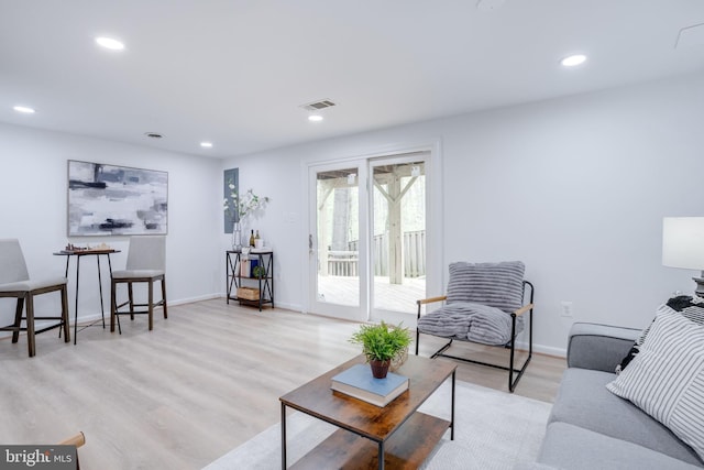 living room with recessed lighting, wood finished floors, visible vents, and baseboards