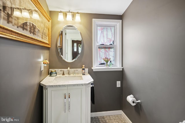bathroom featuring baseboards and vanity